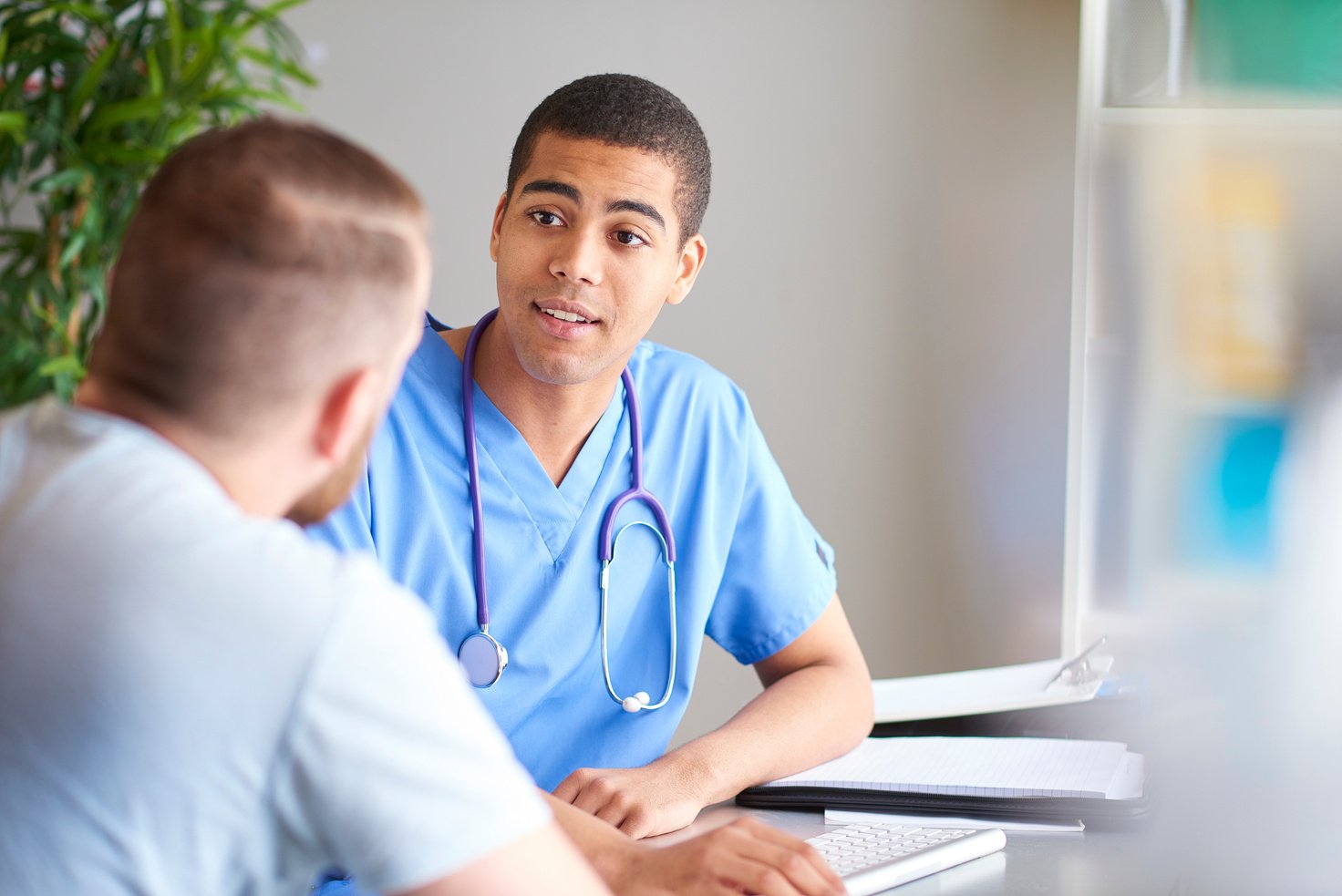 male nurse listening to patient